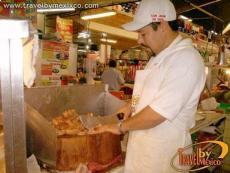 Preparing the traditional smothered sandwich with shredded pork