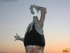 A large polished obsidian stone forms the chest