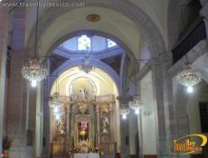 Cruz de cantera rosa ubicada en el altar mayor