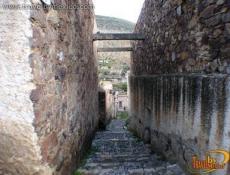 An alley between old ruins, houses protected by INAH (National Institute of Anthropology and History)